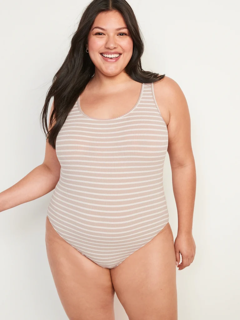 Plus size woman wearing a striped bodysuit.