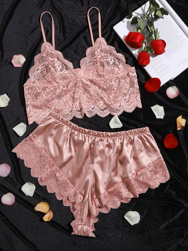 Flat lay of pink lace bralette and short set