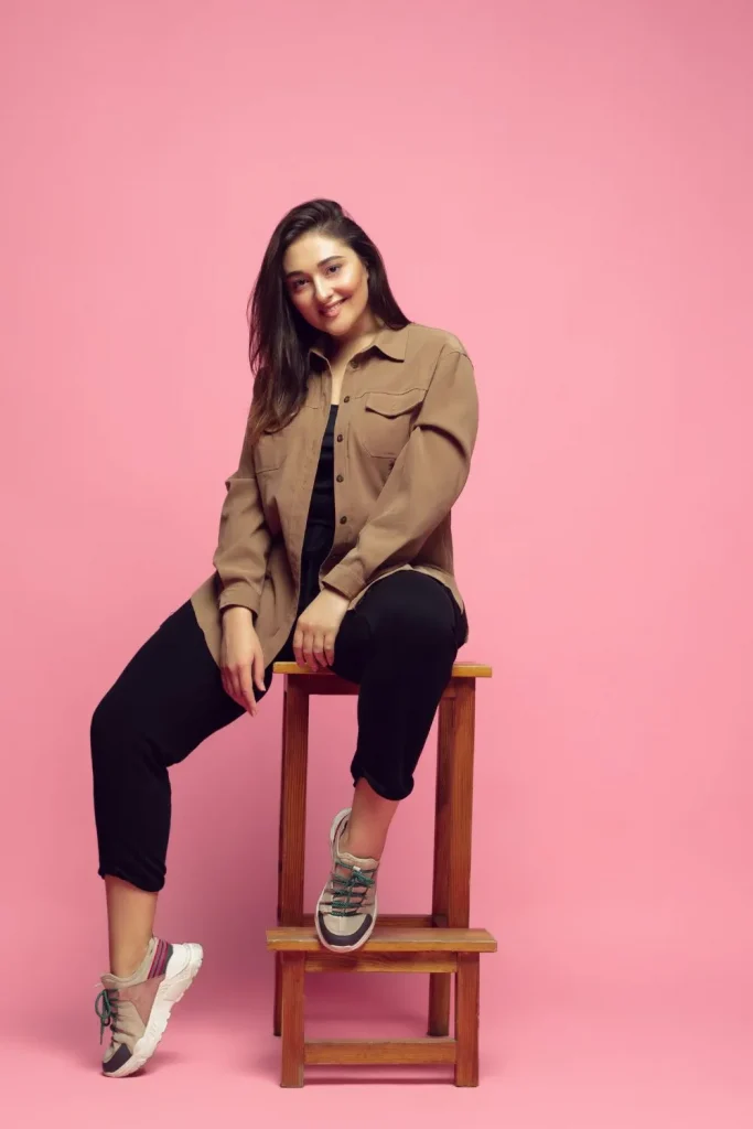 Woman sitting on a stool - cover image for how to wear ponte pants for plus size post
